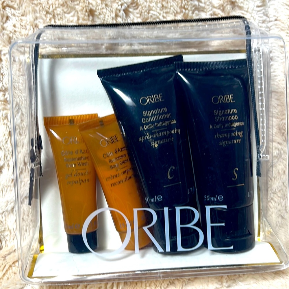 Oribe “The Essentials Set”. Travel size items. In clear plastic travel case